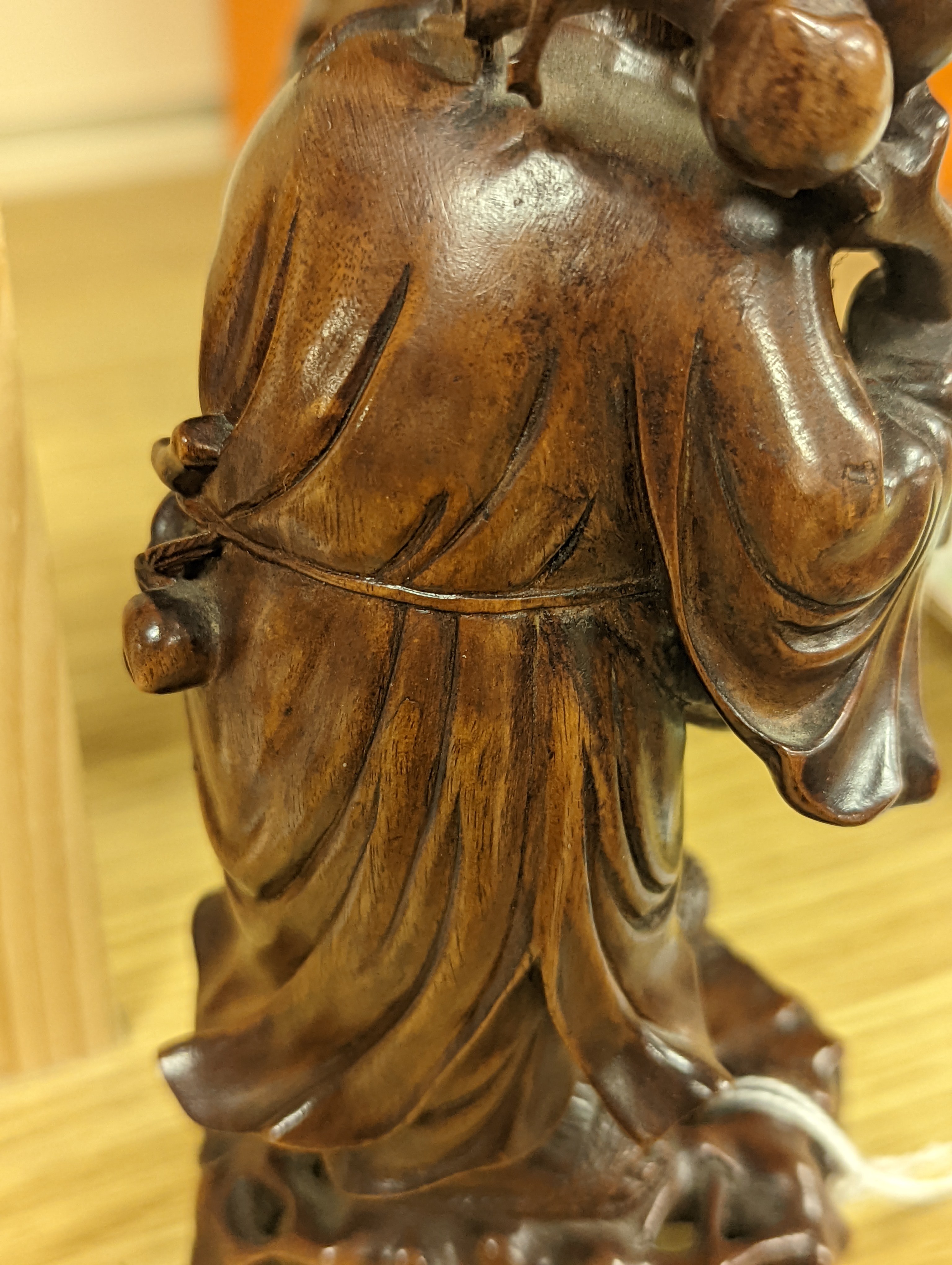 Two Chinese hardwood figures of a fisherman and a old man holding peaches 16cm